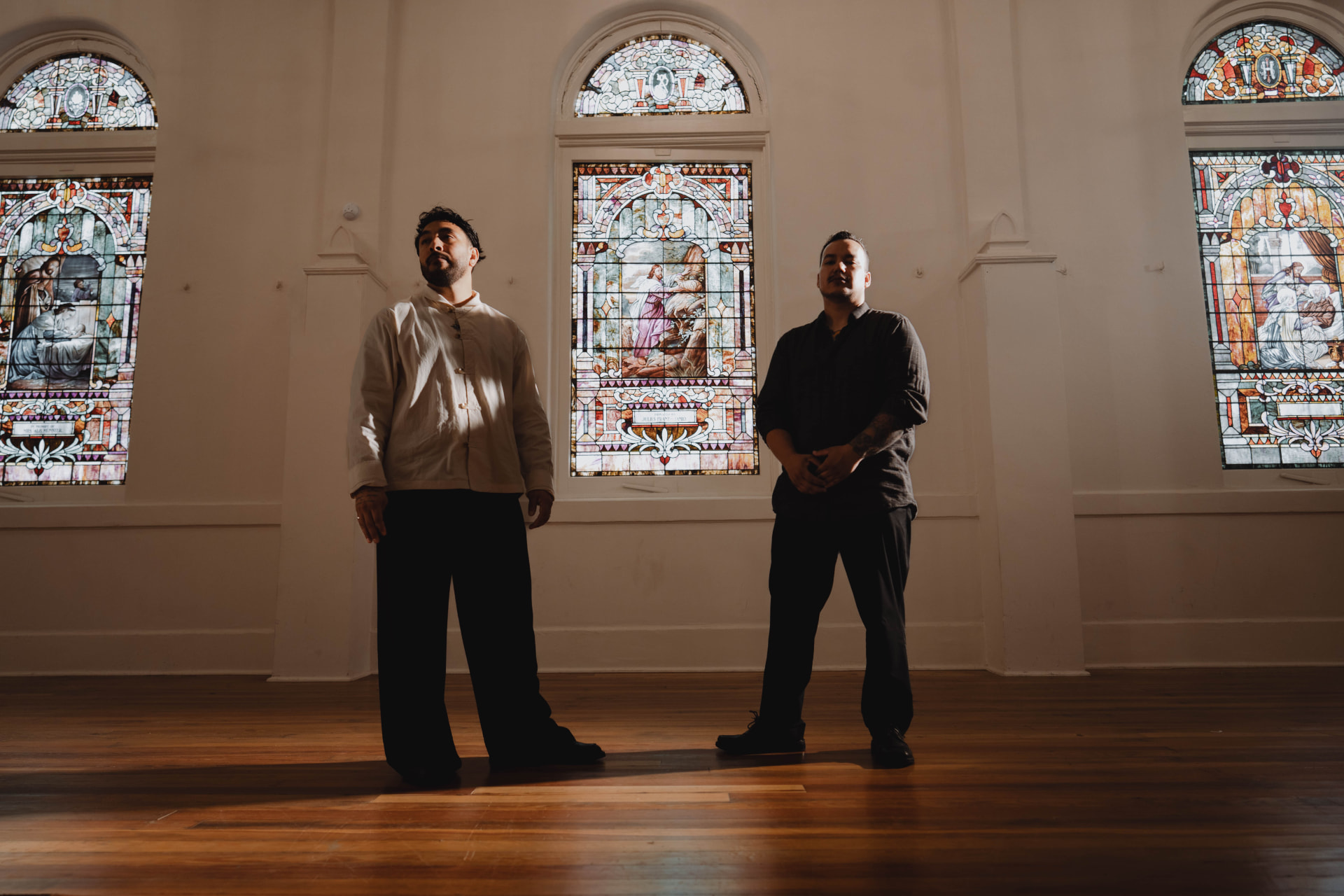 Scroll Eater standing before stained glass windows