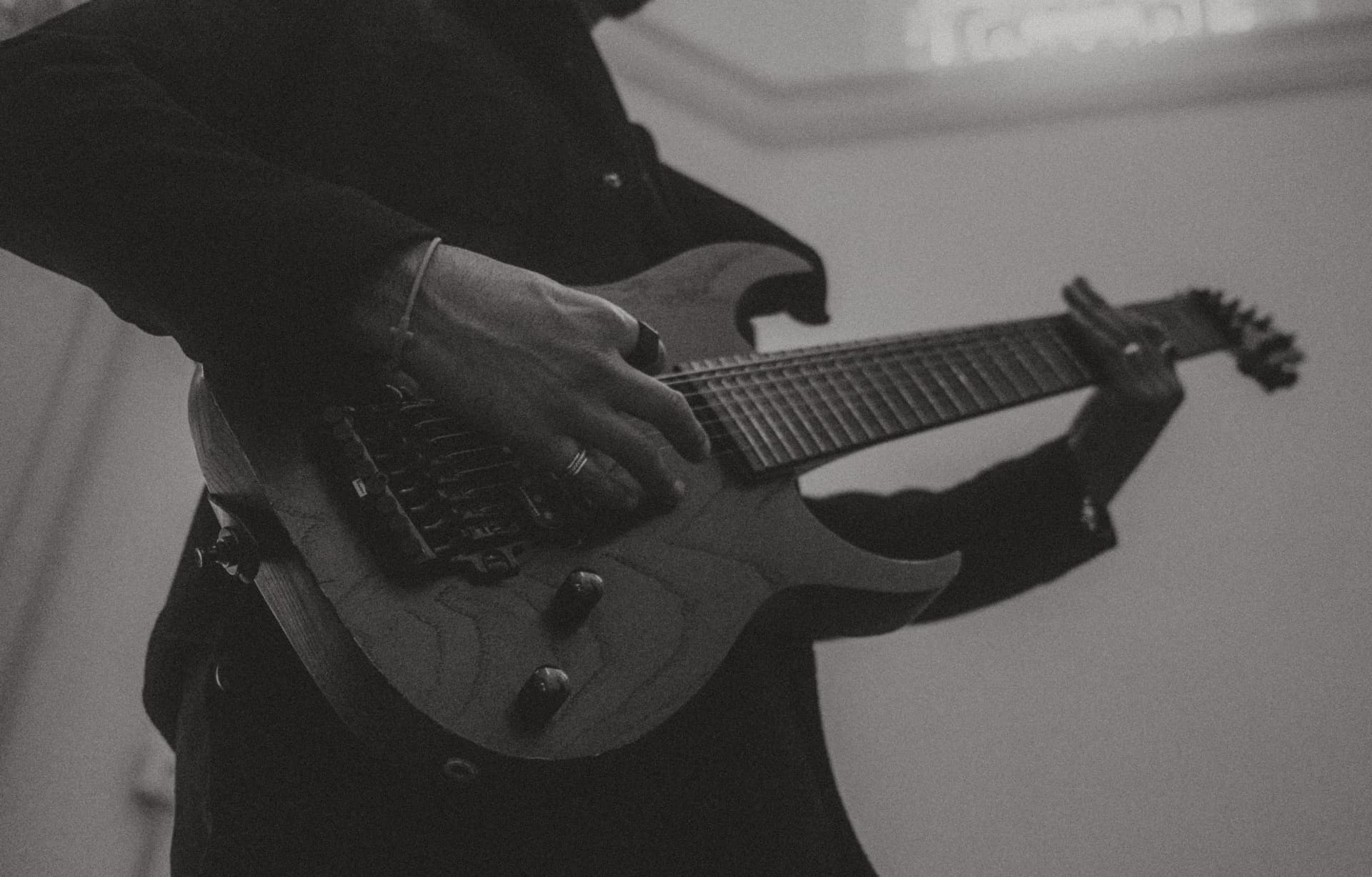 Close-up of hands on an electric guitar